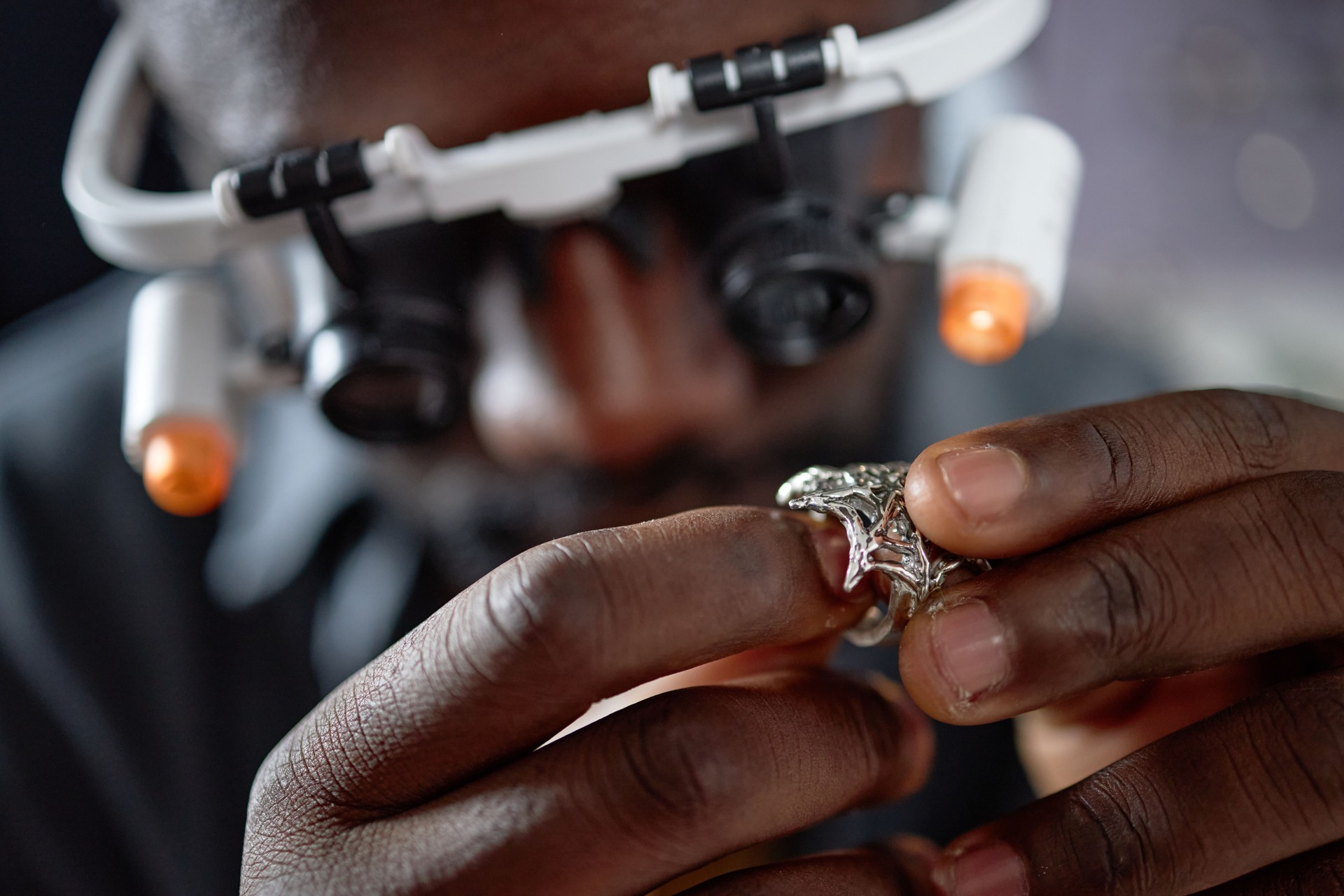 Examining Jewelry Using Magnifying Glass and Headset jewellery fix repair and restoration by Deep Shine Jewellry
